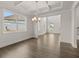 Open-concept living and dining area with hardwood floors, coffered ceiling, and an abundance of natural light at 3910 Near Star Ln, Cumming, GA 30028