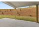 Covered patio with a concrete slab floor, offering a cozy outdoor space to enjoy the peaceful backyard views at 3910 Near Star Ln, Cumming, GA 30028