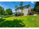 Spacious backyard featuring a slide, deck, and ample green space for outdoor enjoyment at 1130 S Rudder Rd, Cumming, GA 30041