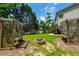 Charming backyard with a fire pit, benches, and landscaped features for relaxation at 1130 S Rudder Rd, Cumming, GA 30041