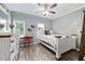 Cozy bedroom with light gray walls, white distressed furniture, and a ceiling fan at 1130 S Rudder Rd, Cumming, GA 30041