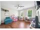 Bedroom features hardwood floors, two windows, overhead lighting, and play area at 1130 S Rudder Rd, Cumming, GA 30041