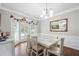 Bright dining room features a white wood table and bay window for ample light at 1130 S Rudder Rd, Cumming, GA 30041