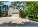 Home exterior showcasing the driveway, garage, and well-maintained landscaping at 1130 S Rudder Rd, Cumming, GA 30041