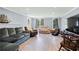 Spacious living room features ample seating, hardwood floors, neutral walls, and natural light from the windows at 1130 S Rudder Rd, Cumming, GA 30041