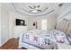 Inviting main bedroom featuring a tray ceiling, large bed, and a dresser with a TV at 1130 S Rudder Rd, Cumming, GA 30041
