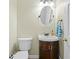 Cozy powder room with a modern vanity, oval mirror, and neutral wall color at 1130 S Rudder Rd, Cumming, GA 30041