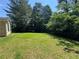 Nice green lawn in the backyard that is partly shaded by mature trees at 120 Squirrel Way, Atlanta, GA 30349
