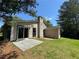View of the backyard with sliding glass door and small cement patio at 120 Squirrel Way, Atlanta, GA 30349