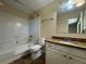 Well-maintained bathroom featuring a shower-tub combo and granite vanity at 120 Squirrel Way, Atlanta, GA 30349