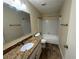 Well-lit bathroom with granite countertops, updated fixtures, and a bathtub-shower combination at 120 Squirrel Way, Atlanta, GA 30349