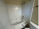 Bright bathroom featuring a white tiled shower and tub combination with updated fixtures at 120 Squirrel Way, Atlanta, GA 30349