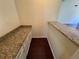 Hallway with granite countertop and cabinetry with dark hardwood flooring at 120 Squirrel Way, Atlanta, GA 30349