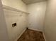 Practical laundry room with tile flooring, shelving and utility connections at 120 Squirrel Way, Atlanta, GA 30349