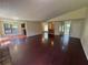 Open living room with dark wood floors, brick accents, and natural light at 120 Squirrel Way, Atlanta, GA 30349