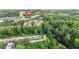 Aerial view of townhomes close to Chick-fil-A and a small river, under a lush tree canopy and blue skies at 3532 Paces Nw Pl, Atlanta, GA 30327