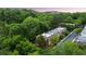 Aerial view of the townhomes surrounded by lush trees; skyline in the distance under a gorgeous blue sky at 3532 Paces Nw Pl, Atlanta, GA 30327