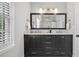 Bathroom featuring a double vanity with marble countertops and dark wood cabinetry at 3532 Paces Nw Pl, Atlanta, GA 30327