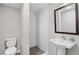 Modern bathroom features a walk-in shower with white subway tile and a pedestal sink with a wood trimmed mirror at 3532 Paces Nw Pl, Atlanta, GA 30327