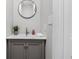 Powder room with gray vanity, mirror, white sink, and modern fixtures at 3532 Paces Nw Pl, Atlanta, GA 30327