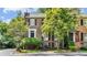 Charming two-story brick townhome featuring black shutters and lush landscaping at 3532 Paces Nw Pl, Atlanta, GA 30327