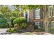 Inviting brick townhome entrance with well-maintained landscaping and curved staircase at 3532 Paces Nw Pl, Atlanta, GA 30327