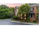 Brick home featuring manicured landscaping, black shutters, and trees during sunset at 3532 Paces Nw Pl, Atlanta, GA 30327