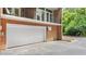 Garage door on the brick home with black wrought iron balcony above and well-maintained landscaping at 3532 Paces Nw Pl, Atlanta, GA 30327