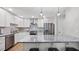 Bright kitchen with stainless steel appliances, white cabinets, granite countertops, and a stylish island with seating at 3532 Paces Nw Pl, Atlanta, GA 30327