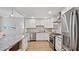 Modern kitchen featuring stainless steel appliances, white cabinetry, and granite countertops at 3532 Paces Nw Pl, Atlanta, GA 30327
