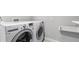 LG washer and dryer in the laundry room with utility sink and updated neutral wall paint and white trim at 3532 Paces Nw Pl, Atlanta, GA 30327
