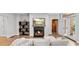 Cozy living room featuring a fireplace, hardwood floors, and access to balcony at 3532 Paces Nw Pl, Atlanta, GA 30327