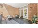 Cozy brick patio with slate floors, seating, and an open doorway leading to the interior at 3532 Paces Nw Pl, Atlanta, GA 30327