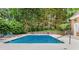 Community pool with chairs and natural fence surrounding the pool for privacy at 3532 Paces Nw Pl, Atlanta, GA 30327
