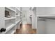 Well-organized walk-in closet with custom shelving and hardwood flooring at 3532 Paces Nw Pl, Atlanta, GA 30327