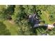 Aerial view of a home nestled among lush trees, surrounded by green spaces, creating a private and serene environment at 5040 Harrington Rd, Johns Creek, GA 30022