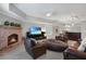 Cozy basement living area featuring a brick fireplace, comfortable seating, and a stylish bar area for entertaining at 5040 Harrington Rd, Johns Creek, GA 30022