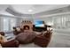 Relaxing basement living room with a brick fireplace, comfortable seating, and plenty of natural light from shuttered windows at 5040 Harrington Rd, Johns Creek, GA 30022