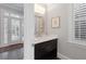 This half bathroom has a modern sink and bright lighting next to french doors at 5040 Harrington Rd, Johns Creek, GA 30022