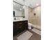 Modern bathroom featuring a glass enclosed shower, dark wood cabinets, herringbone tile flooring, and stylish lighting at 5040 Harrington Rd, Johns Creek, GA 30022