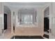 Luxurious bathroom featuring a large soaking tub and tiled shower at 5040 Harrington Rd, Johns Creek, GA 30022