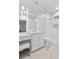 Elegant bathroom with marble flooring, vanity, and glass-enclosed shower, offering a spa-like experience at 5040 Harrington Rd, Johns Creek, GA 30022