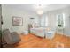Comfortable bedroom with hardwood floors, neutral decor, and natural light, creating a serene atmosphere at 5040 Harrington Rd, Johns Creek, GA 30022