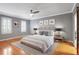 Relaxing bedroom featuring hardwood floors, neutral colors, and ample natural light from multiple windows with white shutters at 5040 Harrington Rd, Johns Creek, GA 30022