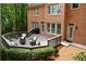Large outdoor deck with seating area surrounded by lush landscaping, offering an excellent space for outdoor gatherings at 5040 Harrington Rd, Johns Creek, GA 30022