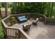 Cozy outdoor deck features stylish wicker seating and views of the surrounding woods at 5040 Harrington Rd, Johns Creek, GA 30022