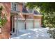 Three car garage with a brick exterior; part of a stately home at 5040 Harrington Rd, Johns Creek, GA 30022