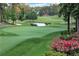 Scenic golf course view features a tranquil pond and vibrant pink flowers at 5040 Harrington Rd, Johns Creek, GA 30022