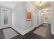 Bright hallway with consistent design, artful wall decor, and elegant light fixtures at 5040 Harrington Rd, Johns Creek, GA 30022