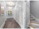 Well-lit hallway with closet, staircase and artwork at 5040 Harrington Rd, Johns Creek, GA 30022